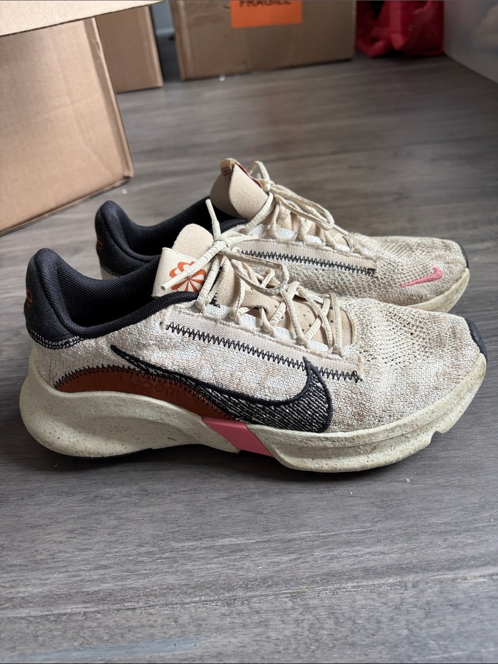 Nike Beige and Black Running Shoes with Pink Accent